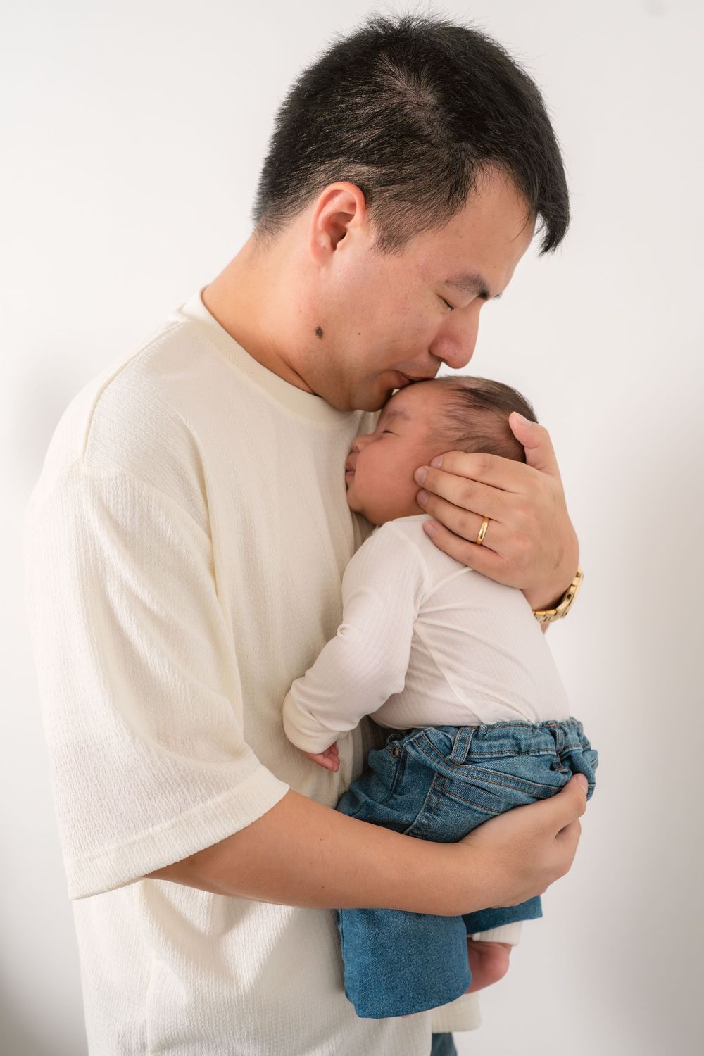 A series of tender moments showing a parent holding and embracing a small child against a white background.
