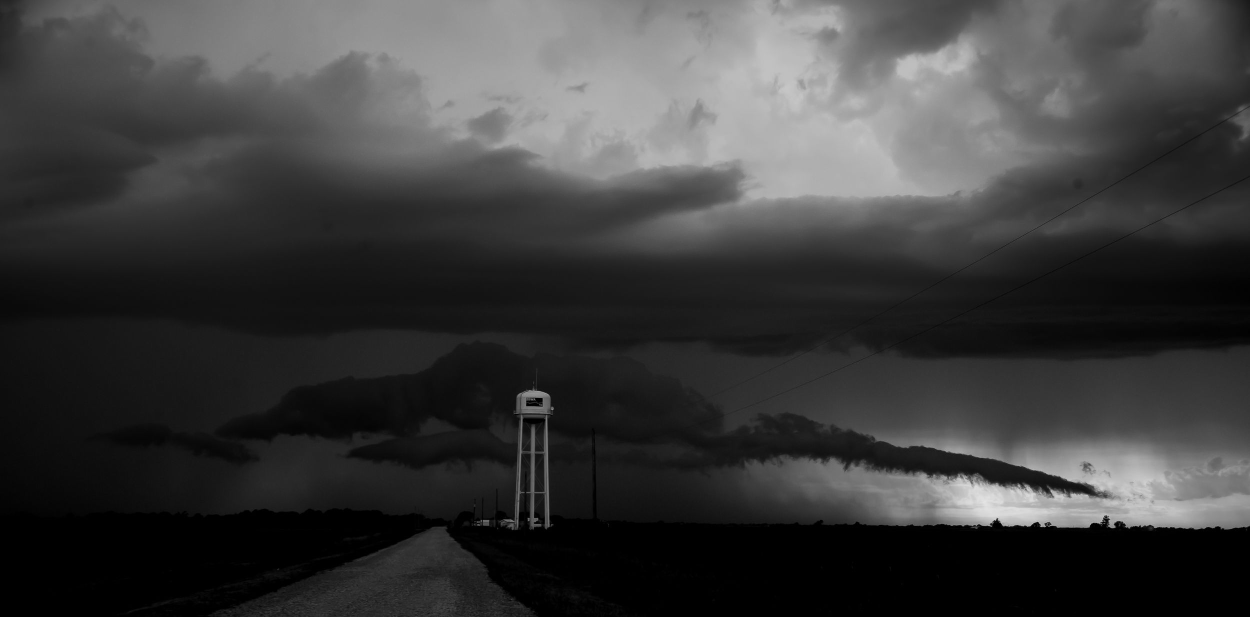 Supercell thunderstorm over water tower rural Southern Iowa black and white
