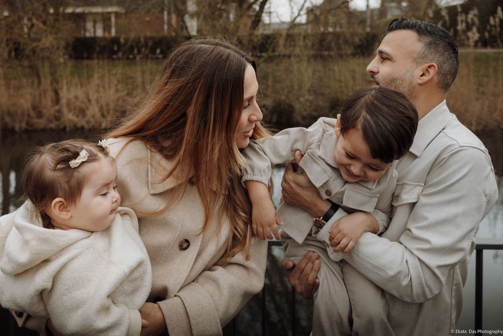 Family in matching white outfits sharing intimate moments outdoors.
