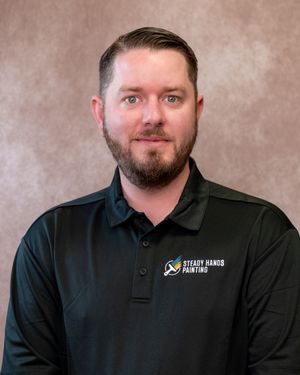 Steady Hands Painting employee in black polo shirt poses for professional headshot photo.