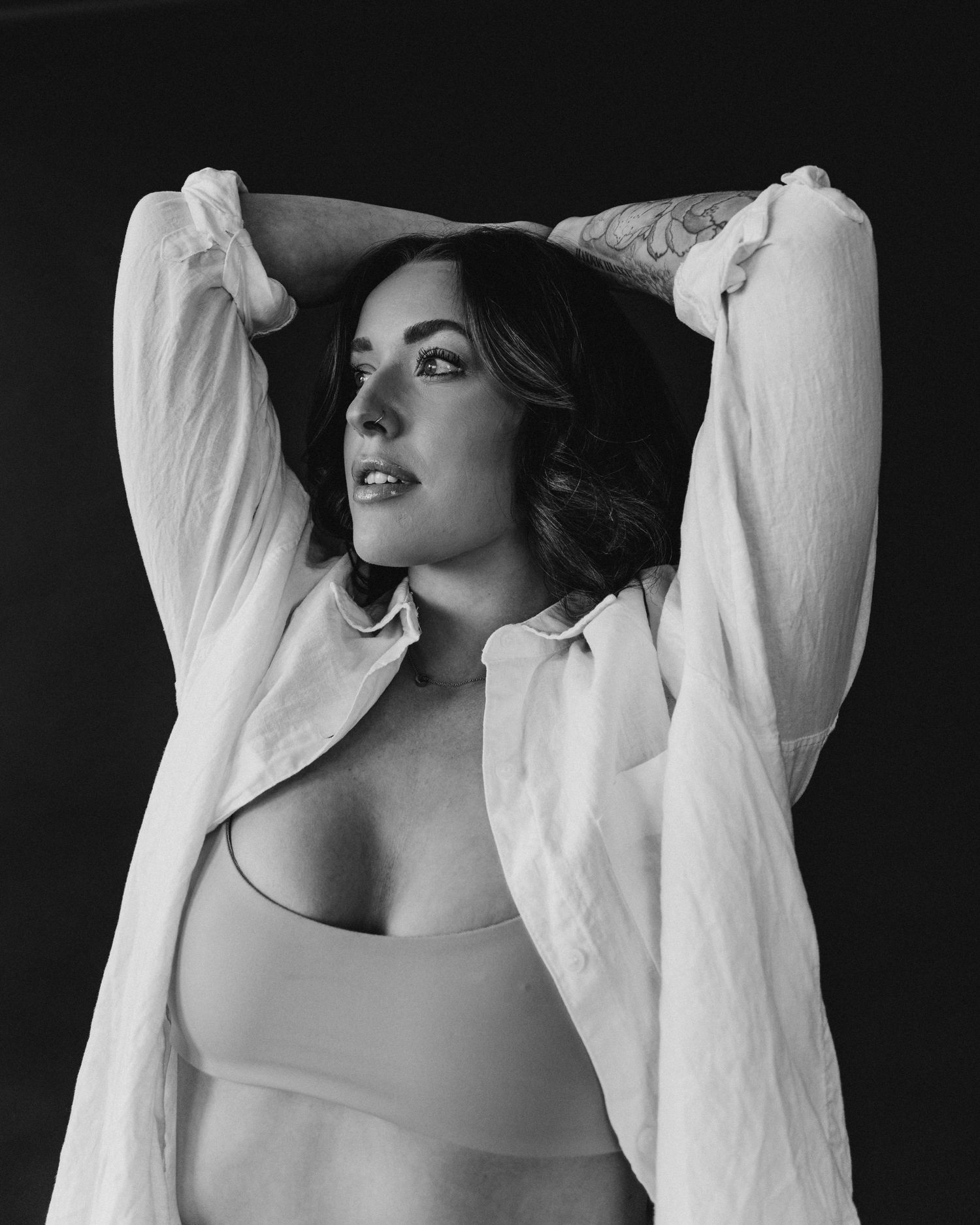 Artistic black and white portrait of person in flowing white garments.