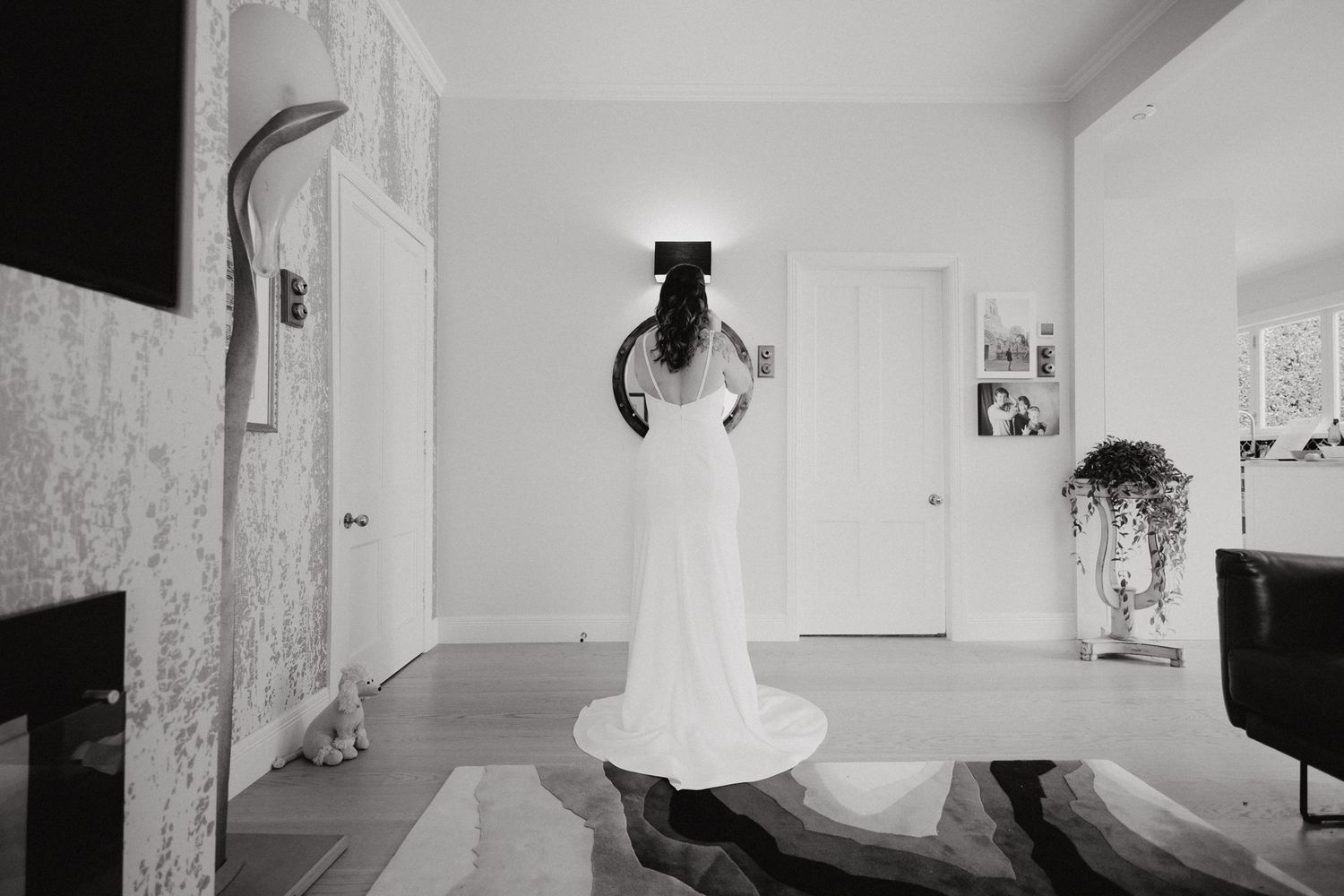 A black and white photograph of the bride in an elegant white wedding gown, captured by Apertured Media Auckland Wedding Photographer.