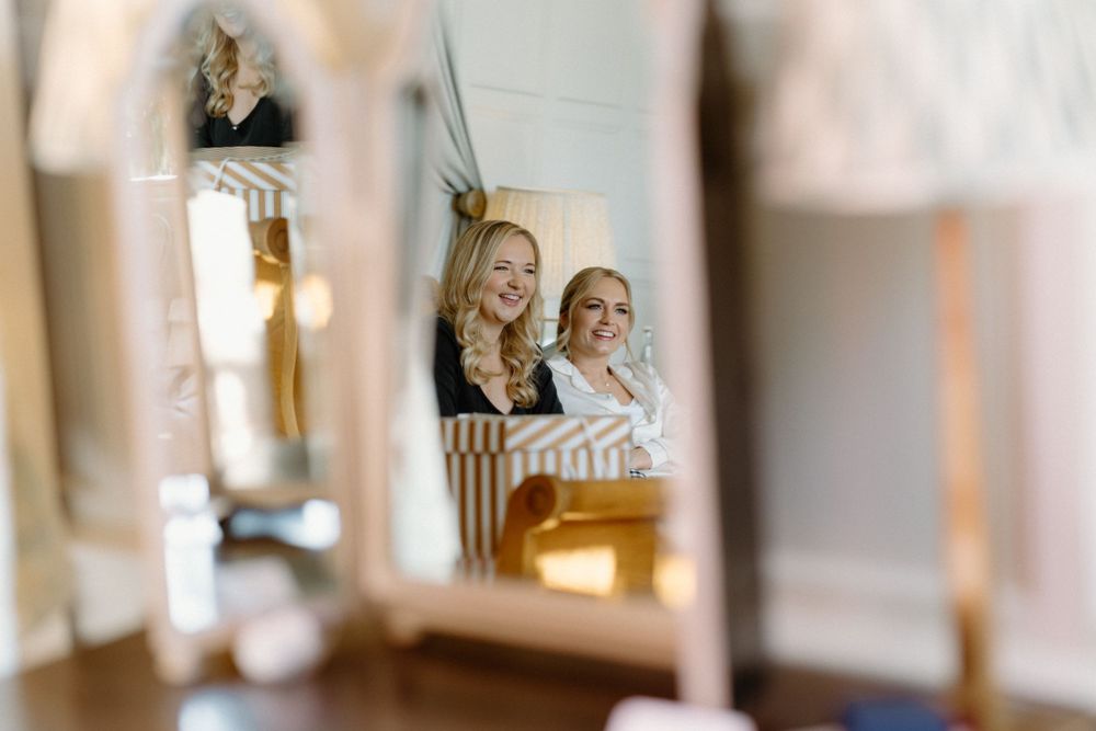 Wedding preparations reflected in a delicate mirror arrangement.