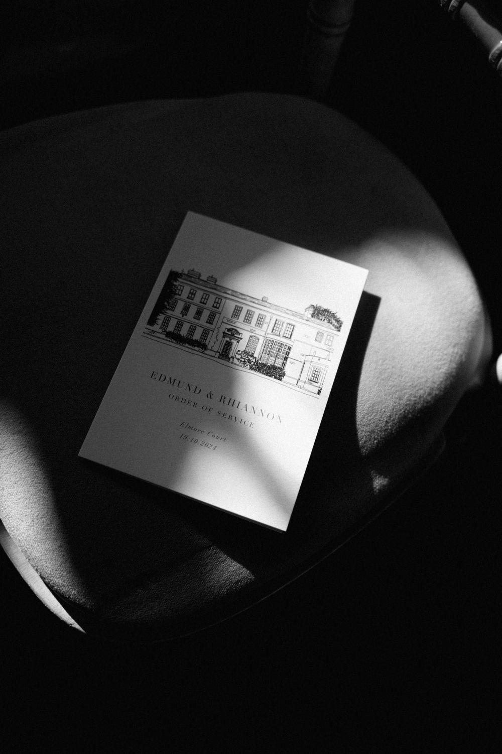 Black and white wedding invitation featuring an elegant building illustration.