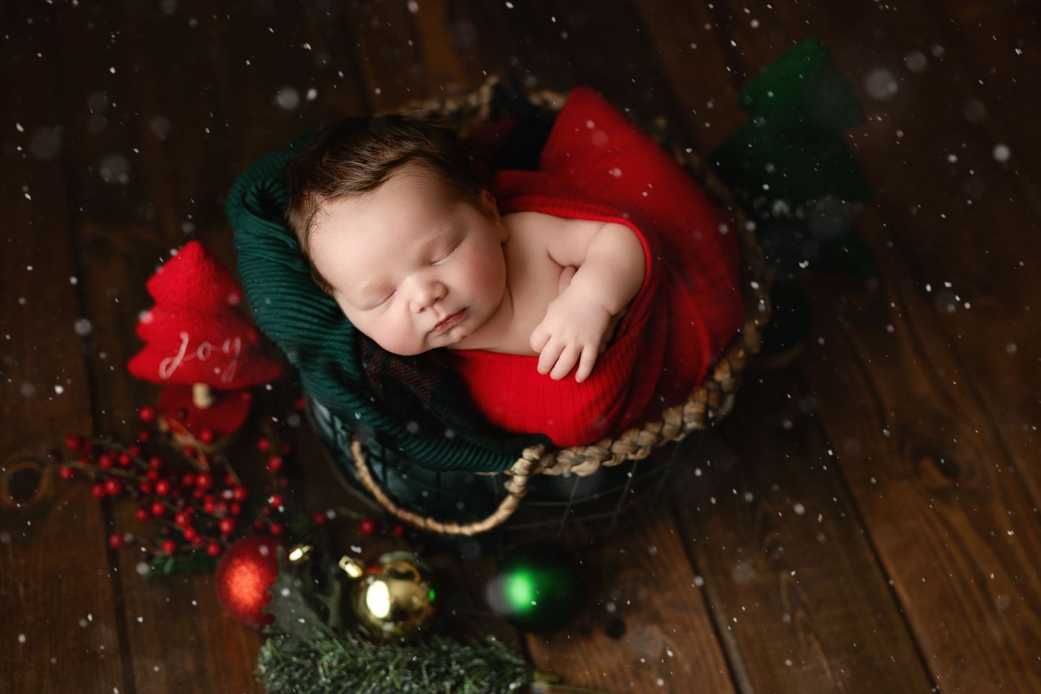 A Christmas-shot newborn is in red and green. Greenville SC newborn photographer, Easley, SC newborn photographer, Upstate newborn photograp