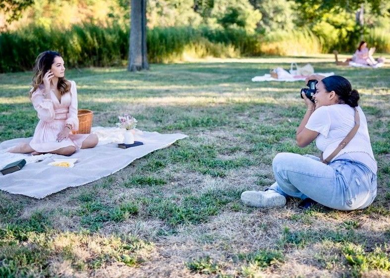 a photographer capturing a lady posing