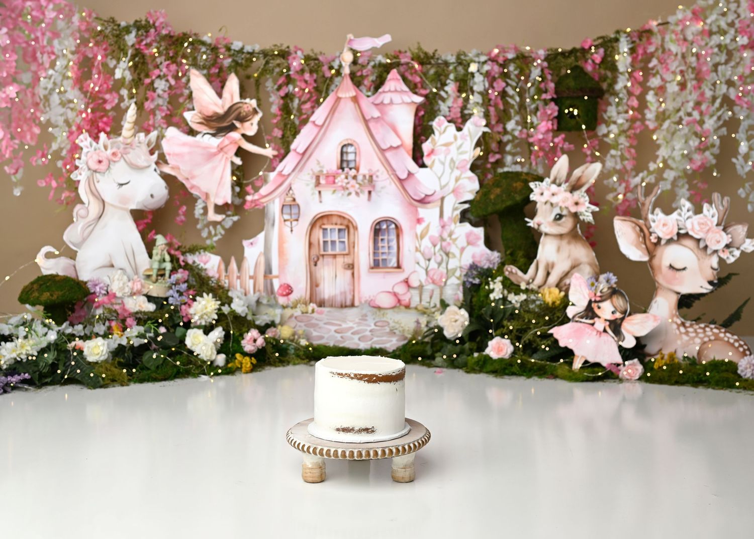 Fairytale pink castle first birthday cake smash setup with florals in Linden, New Jersey.