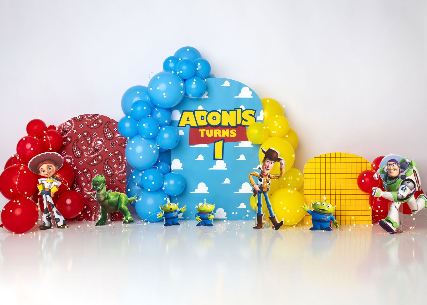 Toy Story themed first birthday cake smash setup with colorful balloons in Linden, New Jersey.