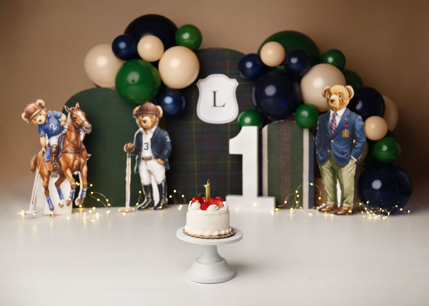 Dark green and gold first birthday cake smash setup with balloon garland in Linden, New Jersey.