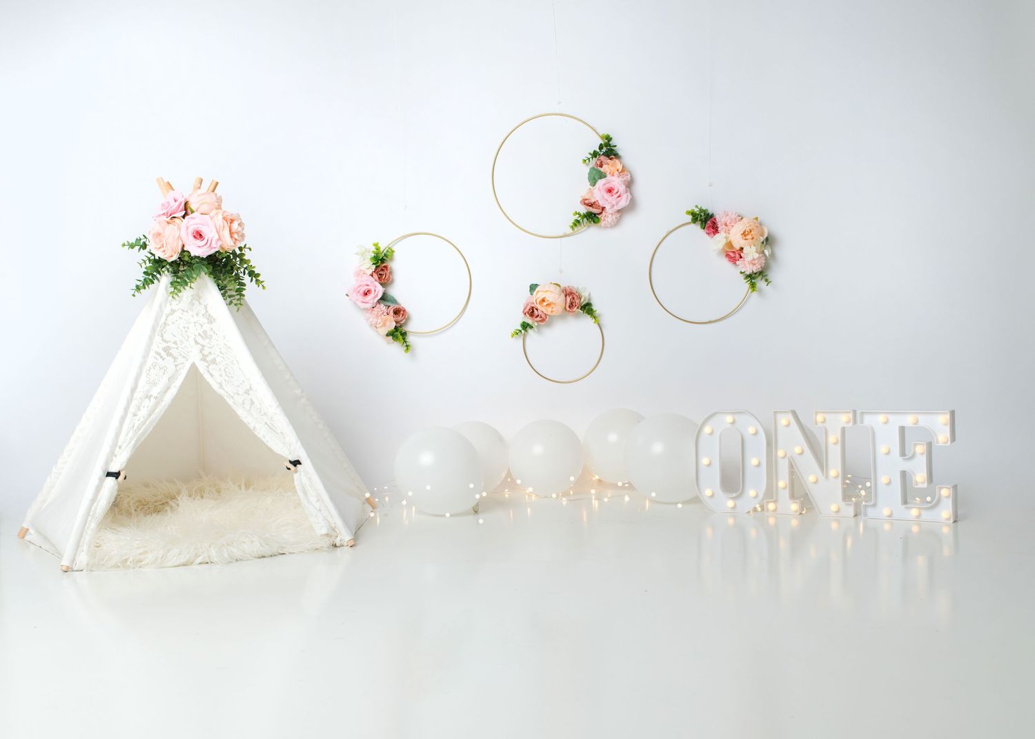 Boho teepee first birthday cake smash setup with soft neutral decor in Linden, New Jersey.
