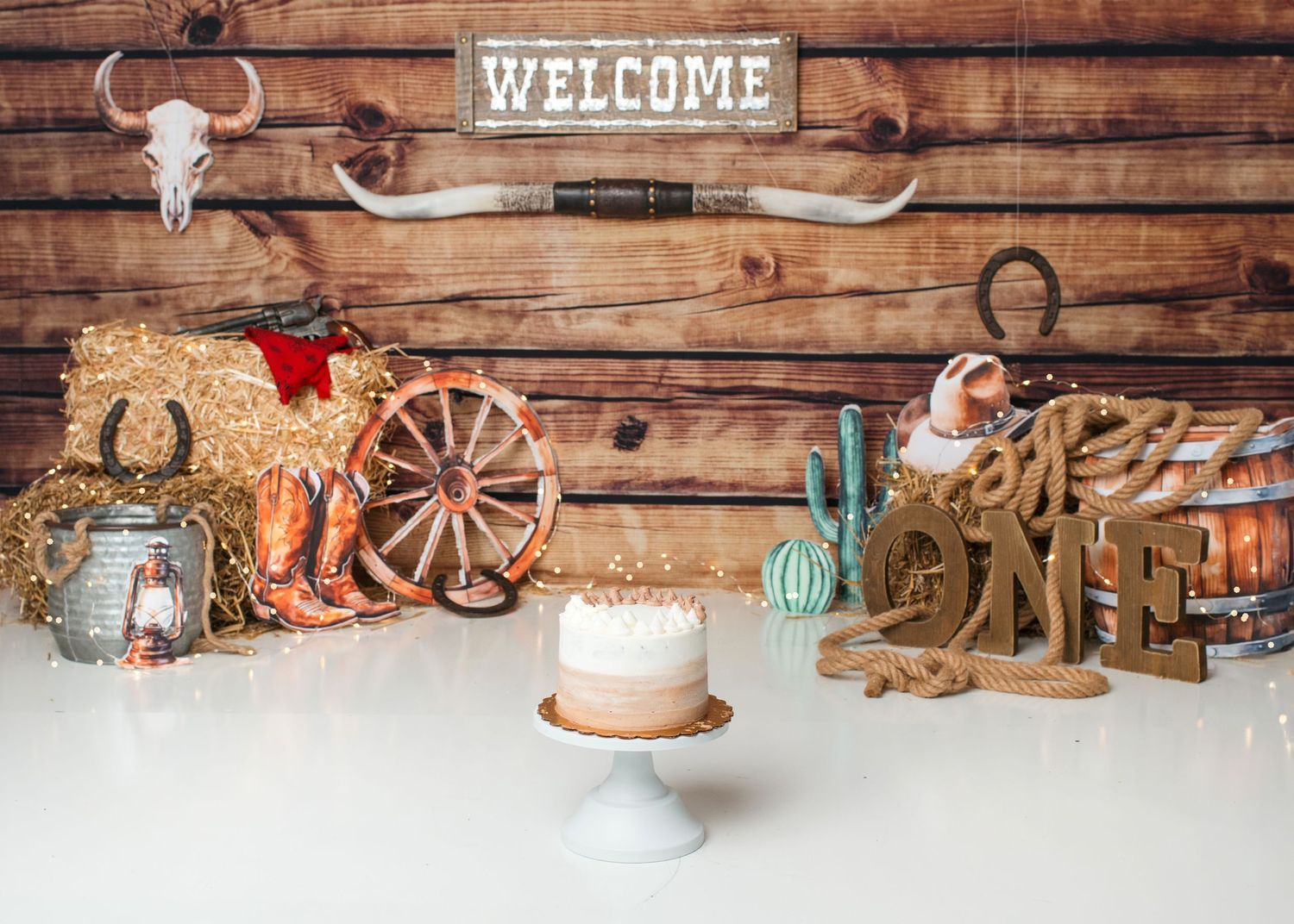 Western cowboy first birthday cake smash setup with rustic wood backdrop in Linden, New Jersey.