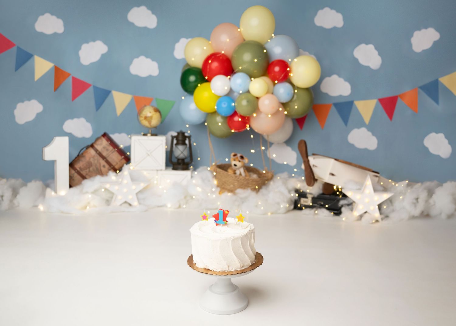 UP themed Colorful carnival inspired first birthday cake smash setup with balloons in Linden, New Jersey.