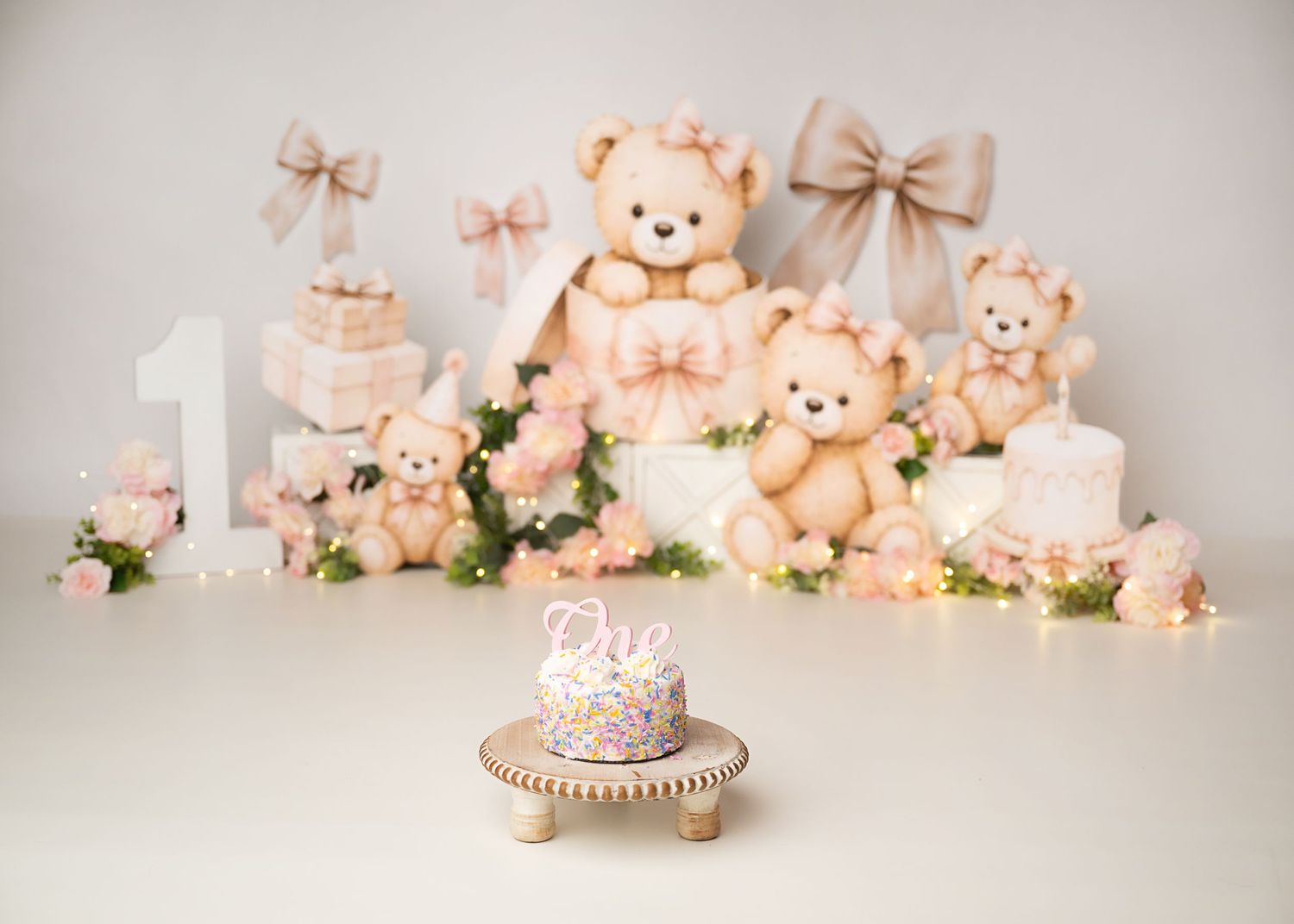 Teddy bear first birthday cake smash setup with peach and cream decor in Linden, New Jersey.