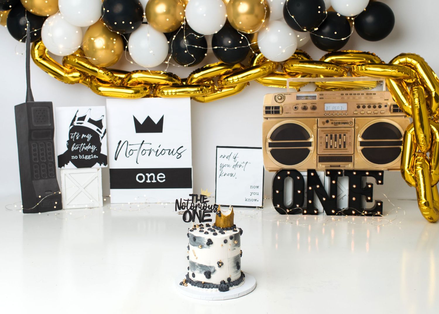 Black and gold music themed first birthday cake smash setup in Linden, New Jersey.