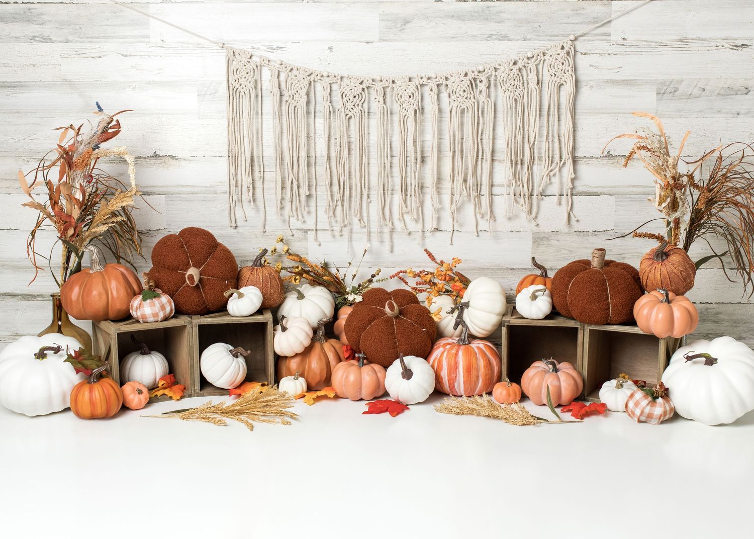 Woodland fall first birthday cake smash setup with brown, green and rust balloons in Linden, New Jersey.