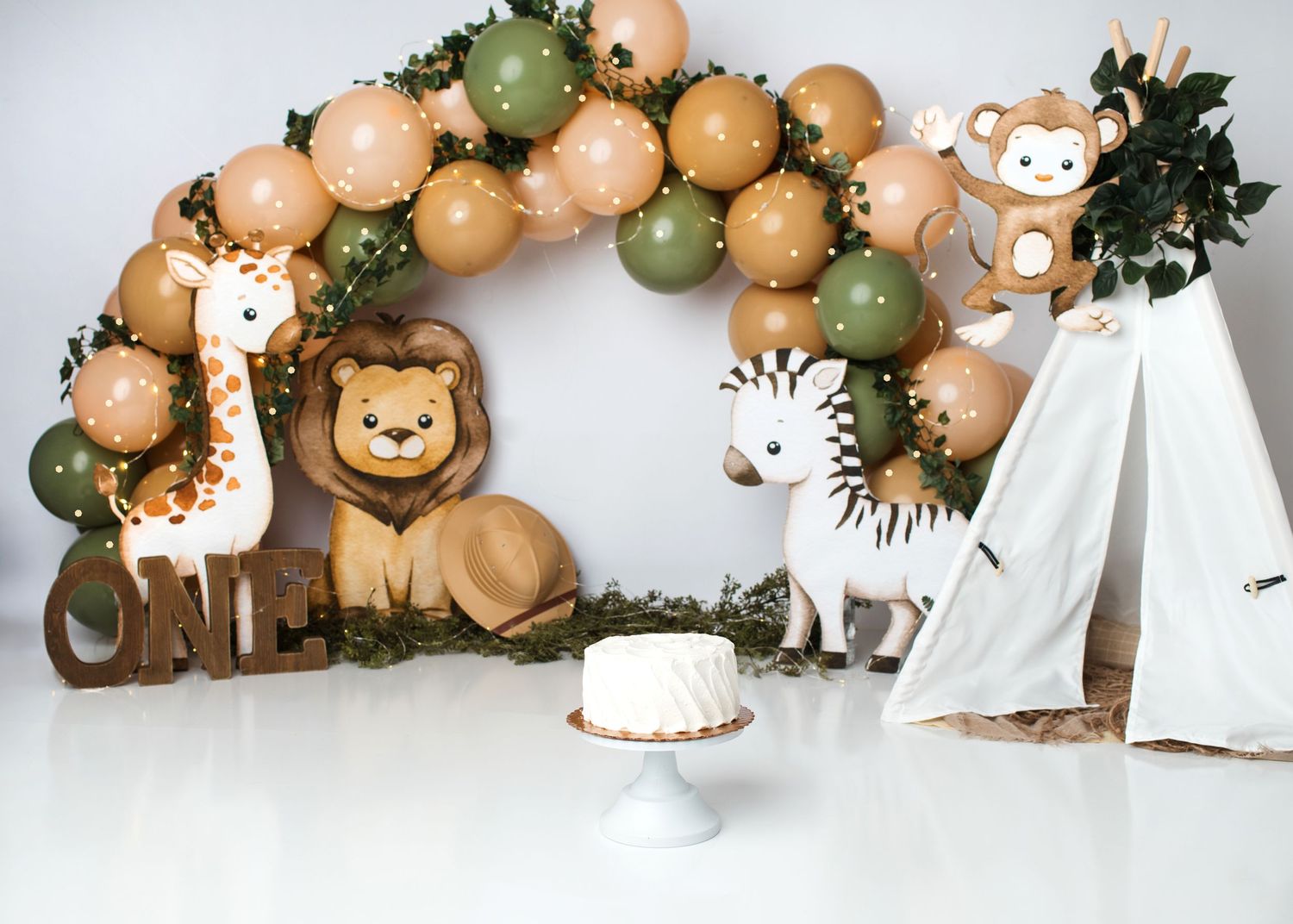 Safari animal first birthday cake smash setup with warm neutral balloons in Linden, New Jersey.
