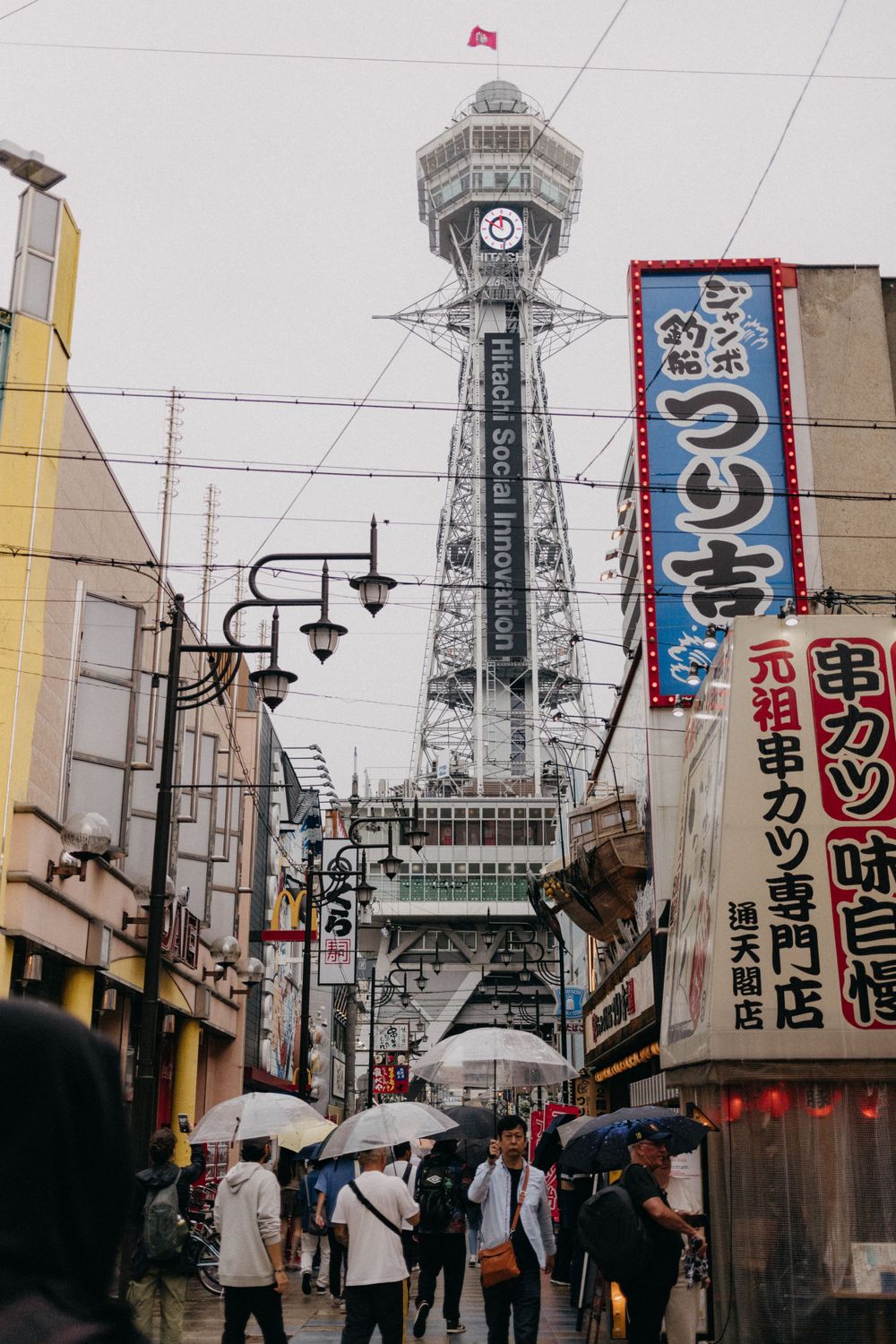 Iconic Tsutenkaku Tower rising above dense urban streets of Osaka.