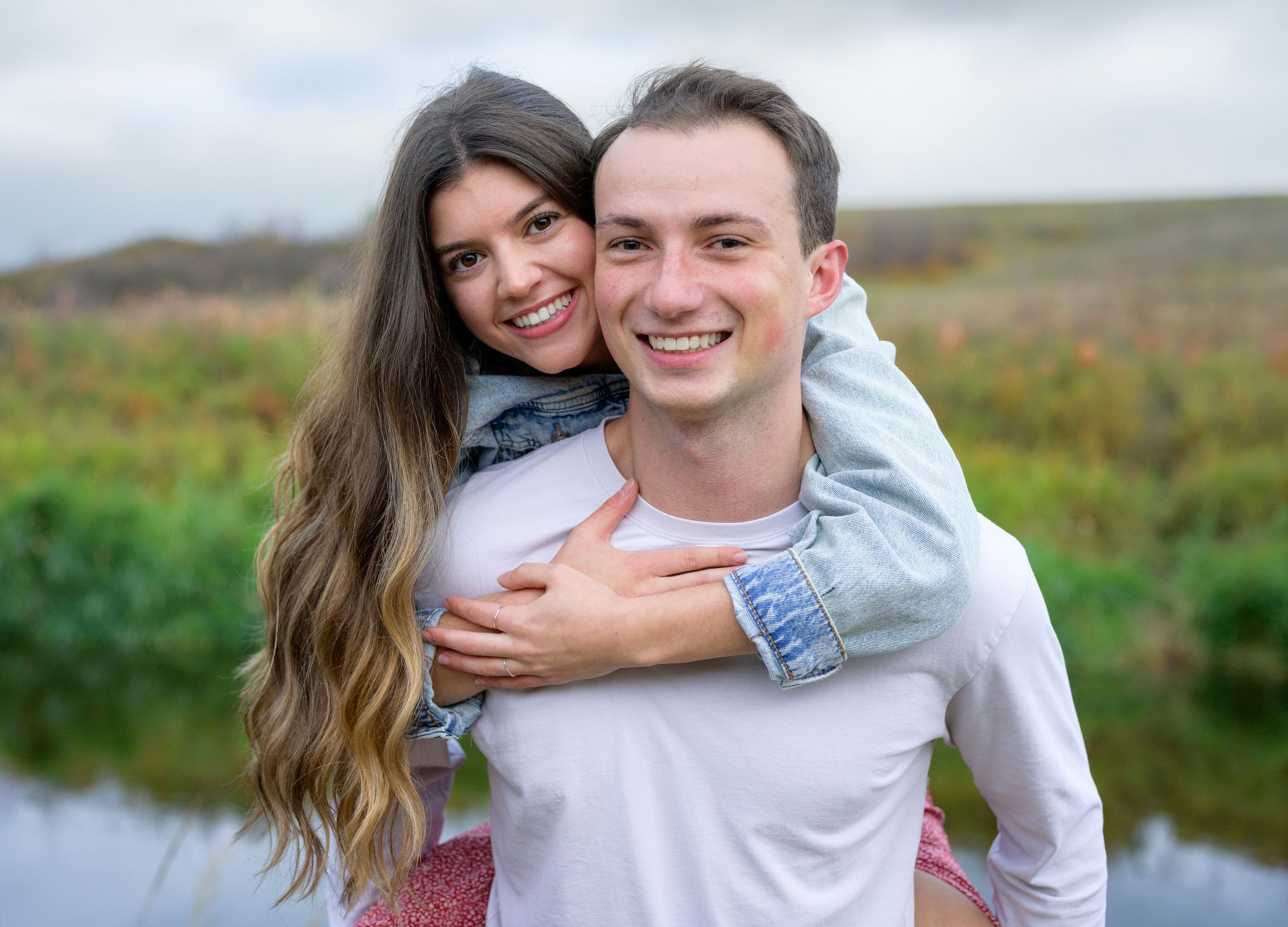 A joyful piggyback ride moment captured in a natural outdoor setting.