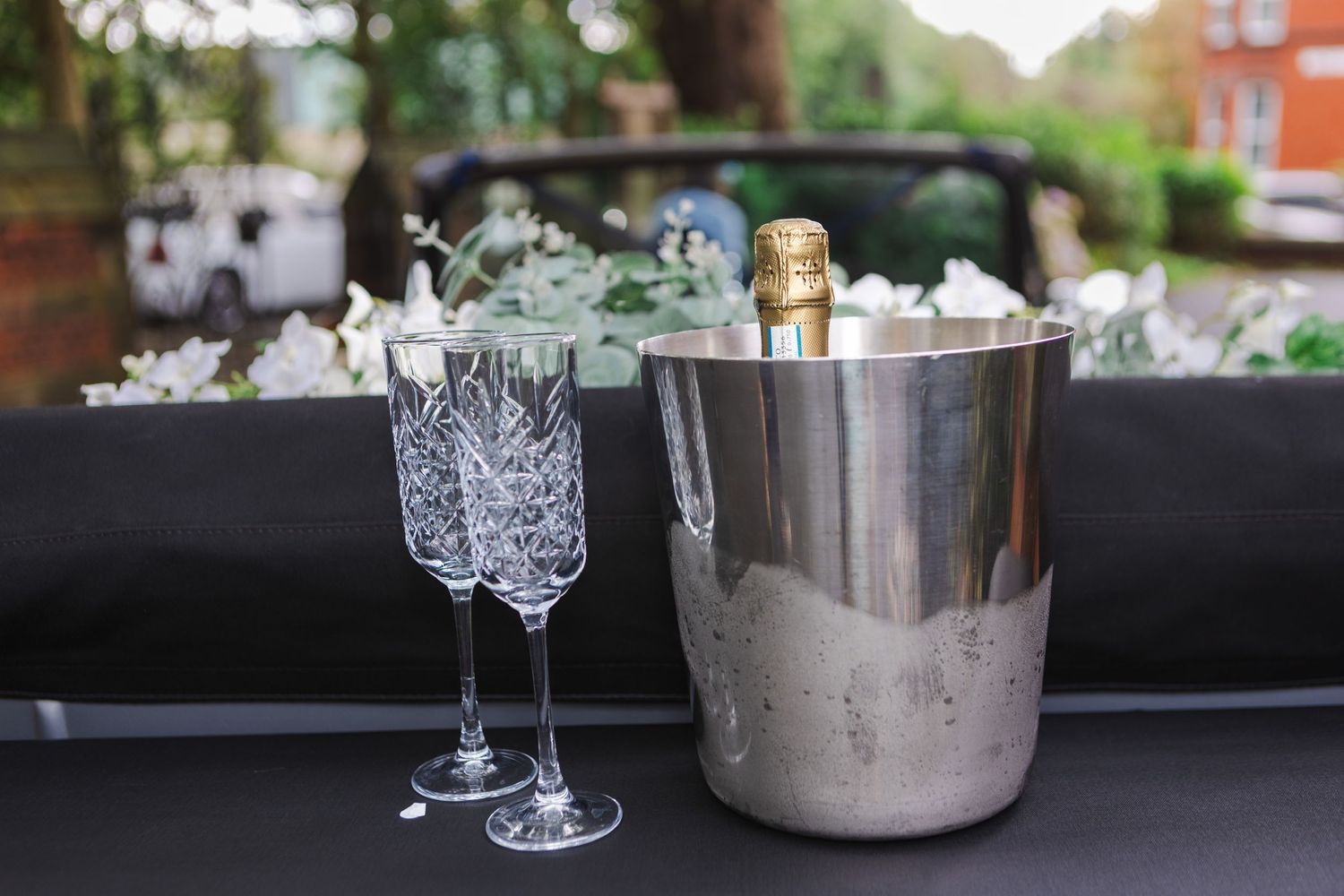 Elegant wedding table setup with crystal glassware and silver decorative elements.