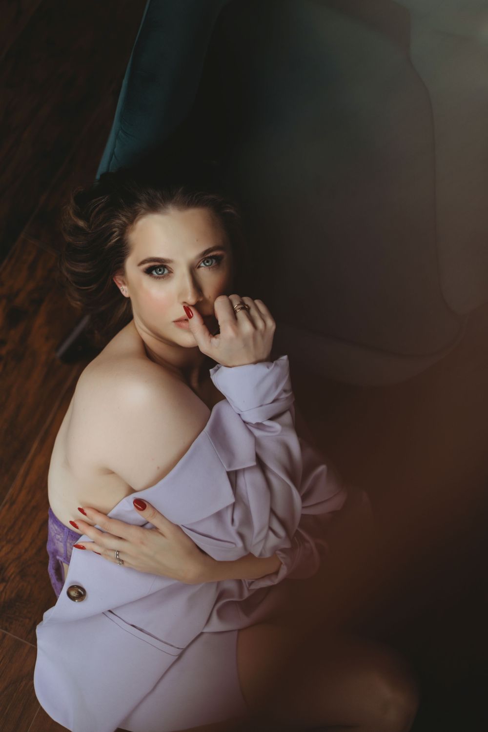 Intimate portrait in purple tones against dark wooden background. Bellevue studio, WA