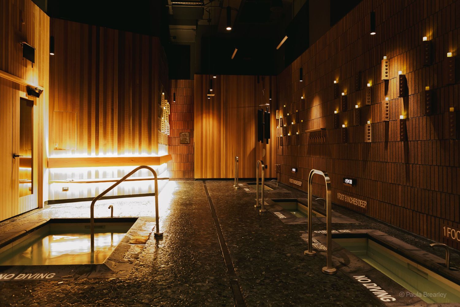 Modern sauna room at Othership Flatiron NYC with soft lighting and cedar wood interiors