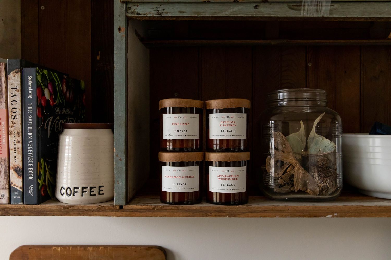 Lineage brand candles on an antique shelf