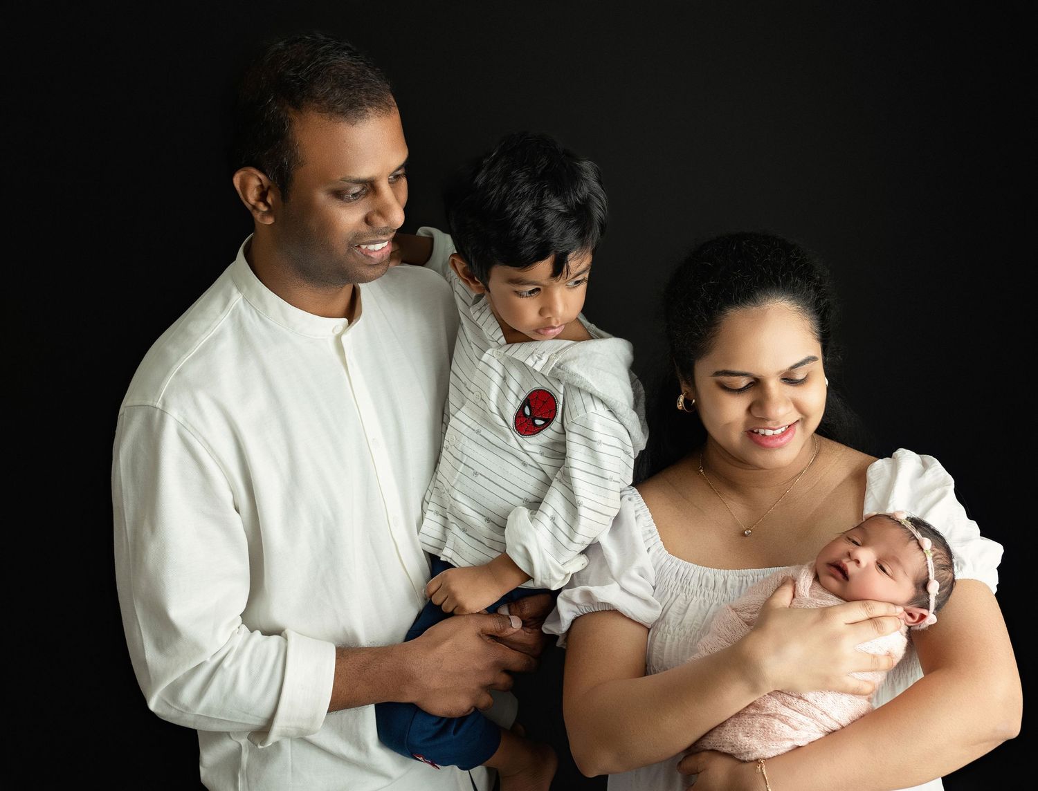 An Indian family holding their newborn. Greenville SC newborn photographer, Easley, SC newborn photographer
