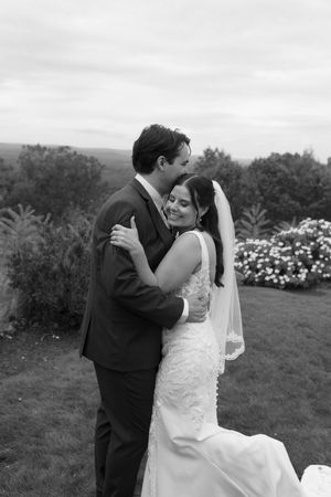 A romantic black and white wedding photo series showing tender moments between a couple in formal attire outdoors.