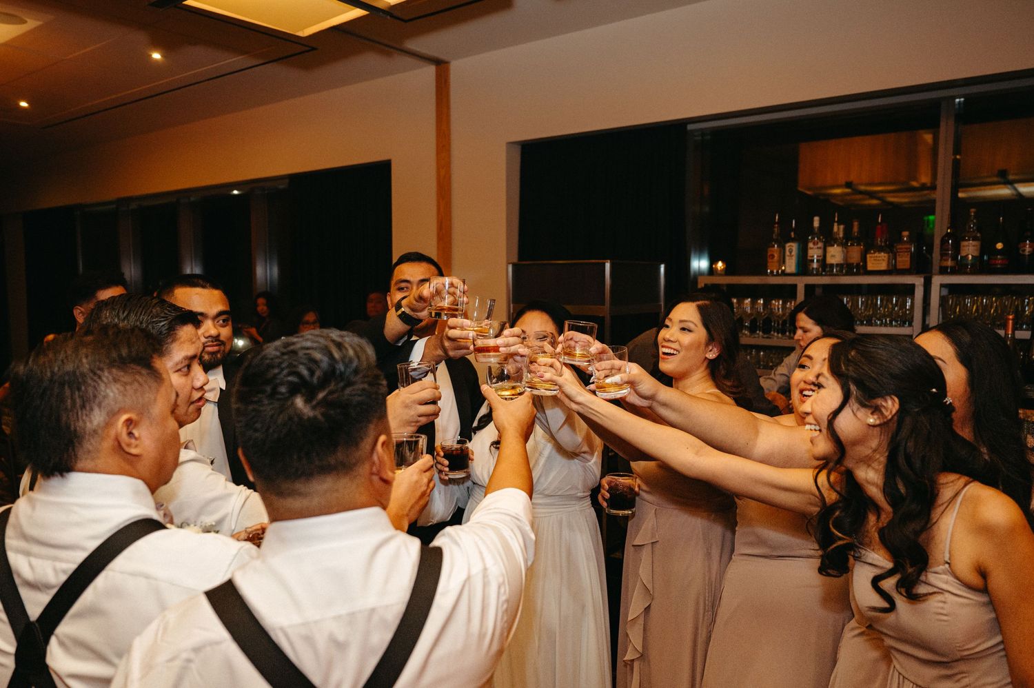 Wedding reception dance party with guests celebrating on the dance floor.