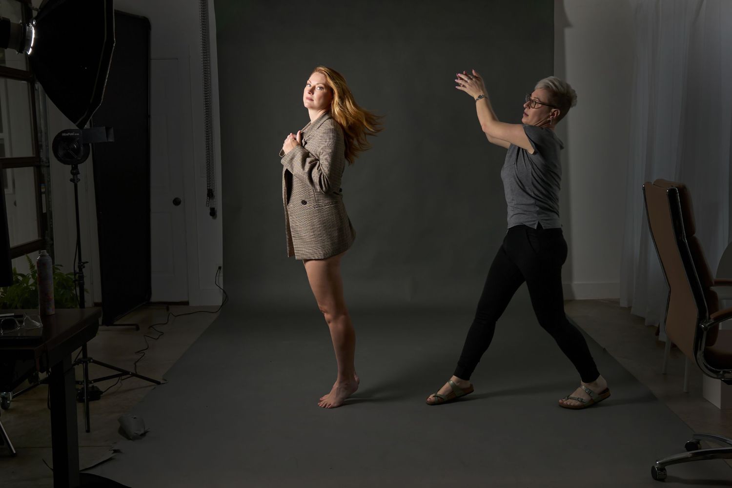 Studio photoshoot setup with dramatic lighting and silhouettes.