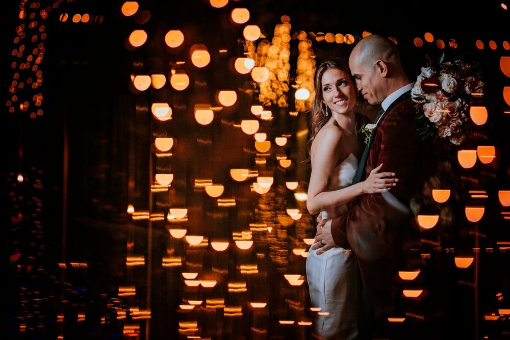 Couple dances intimately surrounded by glowing orange lanterns creating a romantic atmosphere.