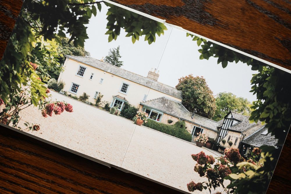 A panoramic view of an elegant white wedding venue with manicured grounds.