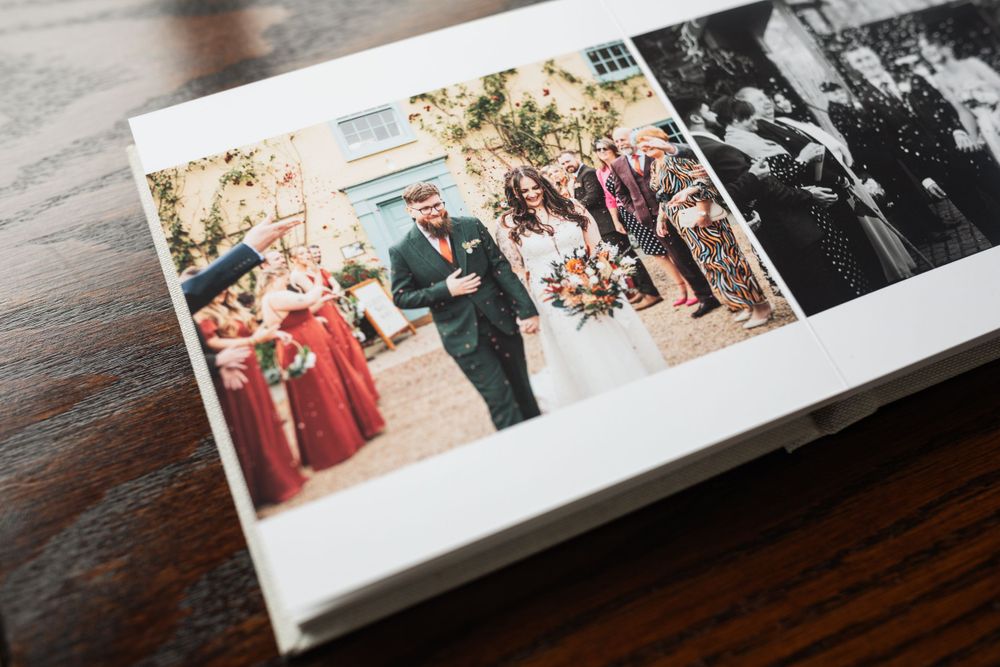 A wedding photo album page showing ceremony moments printed on high-quality paper.