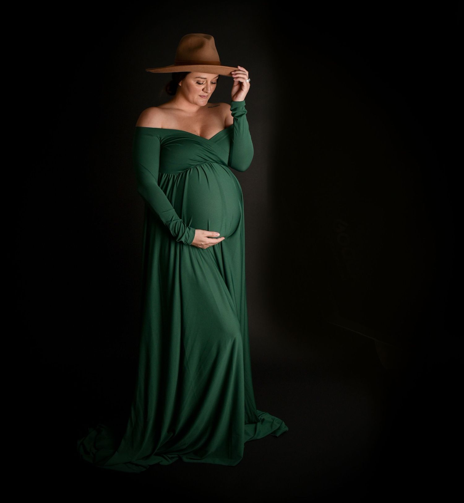 Maternity green dress pose