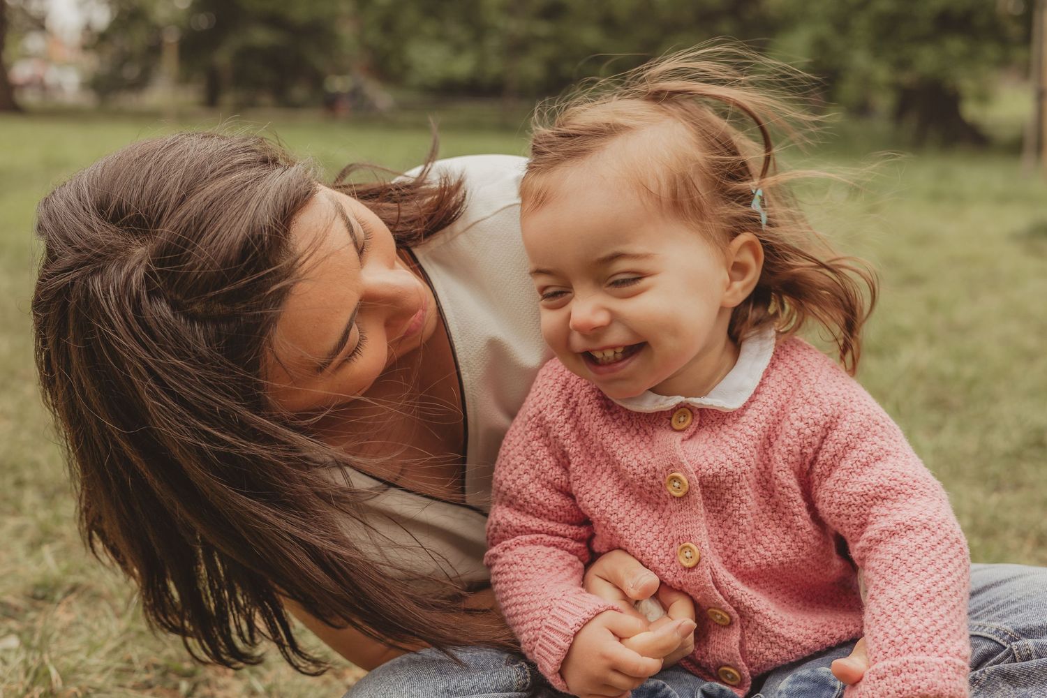 mum and toddler daughter laugh together