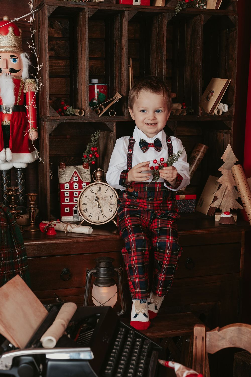 Vintage Christmas scene with plaid decor, nutcrackers, and festive decorations in a cozy wooden setting.