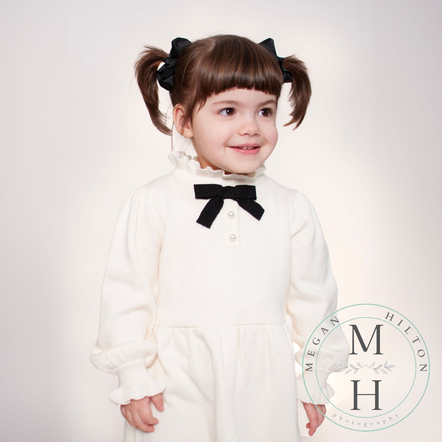 Little toddler girl smiling looking off to the side