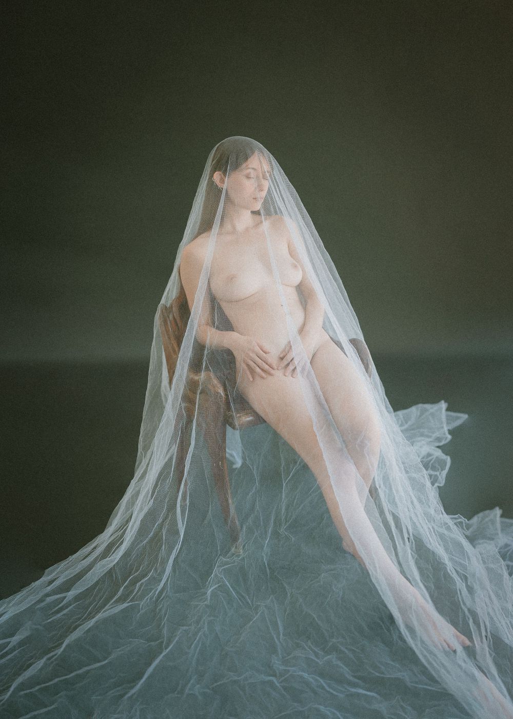 Ethereal nude study with translucent white veil creating dreamy atmosphere.