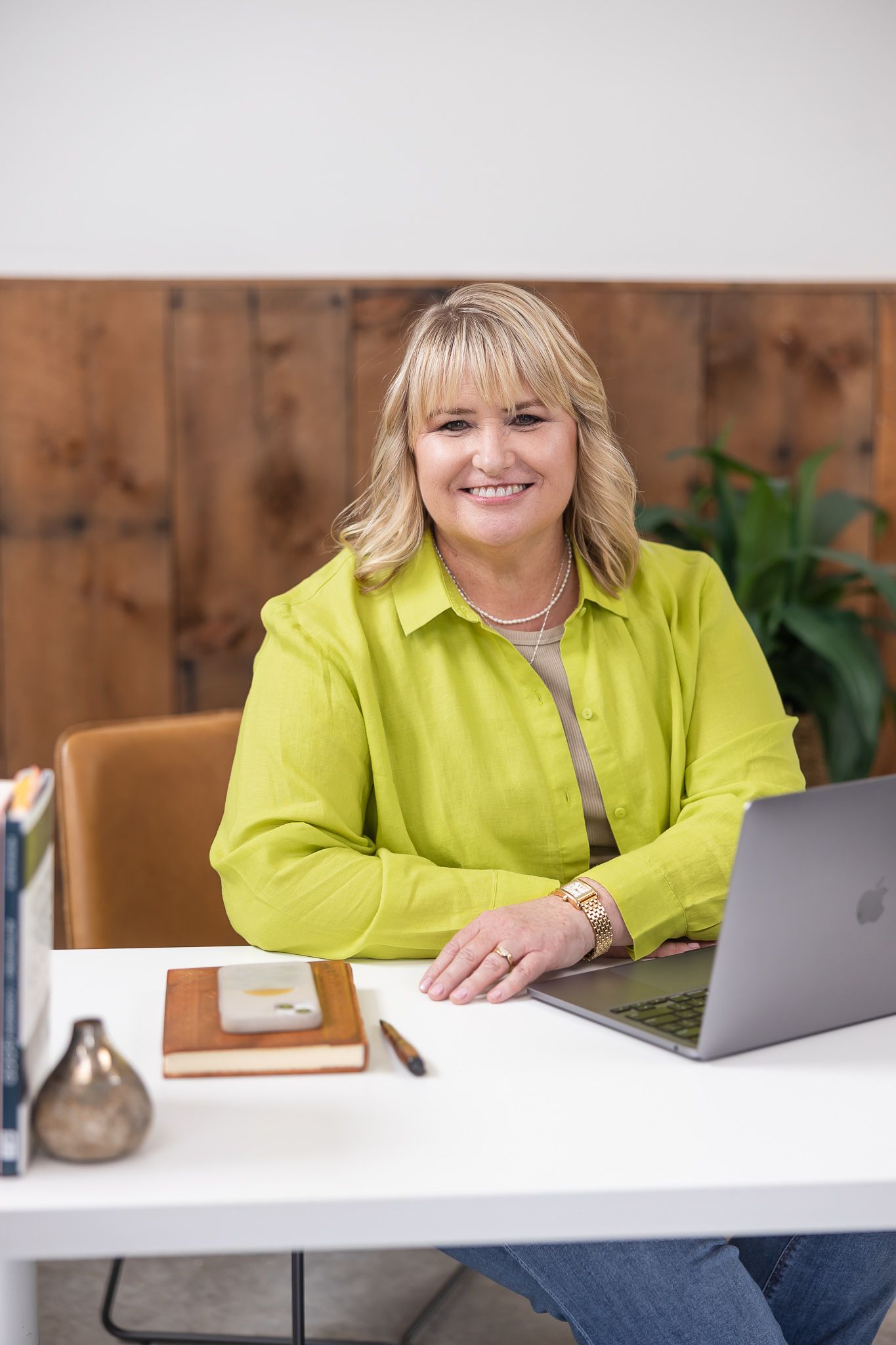 woman business coach sitting at desk in front of laptop for personal branding lifestyle headshot in auburn, WA studio