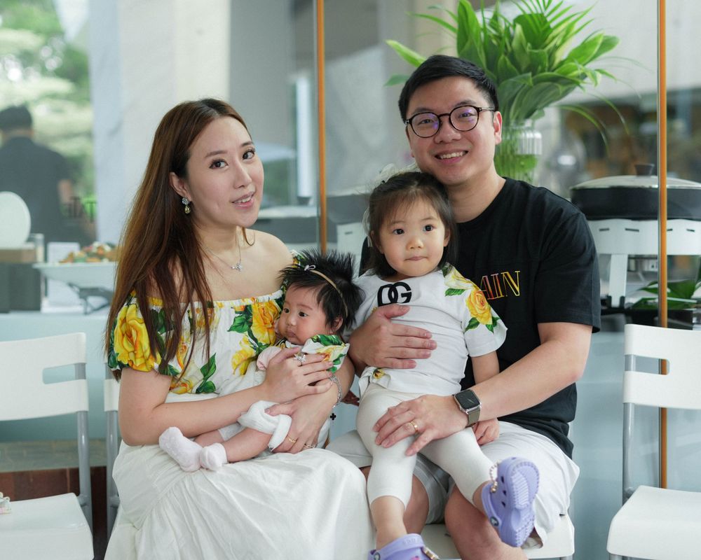 Family portrait at a celebration event in modern indoor setting.