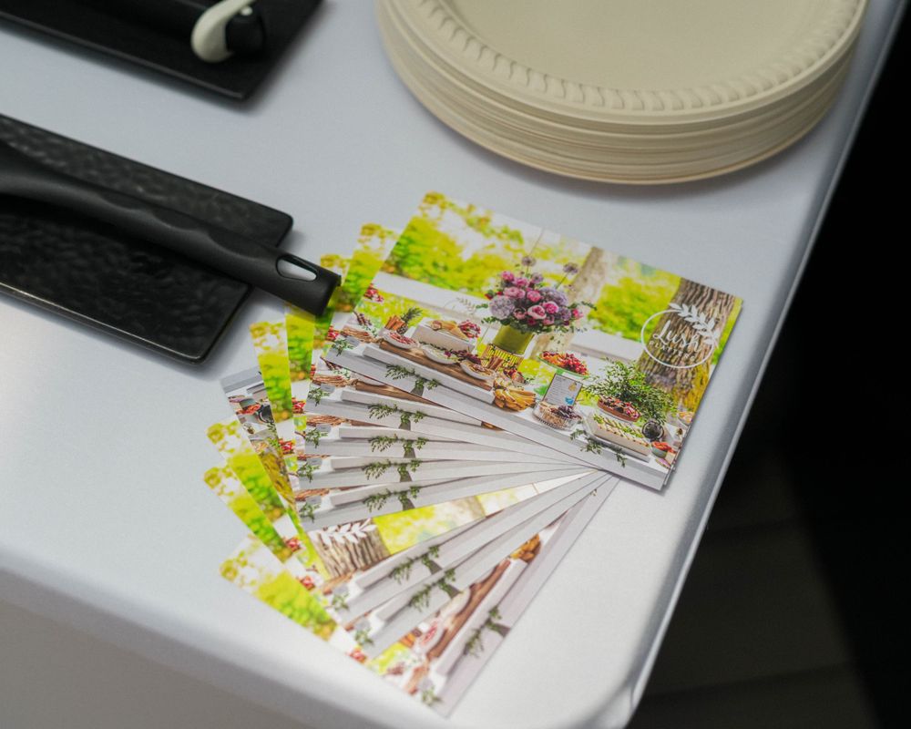 Stack of colorful event tickets or vouchers with floral design elements.