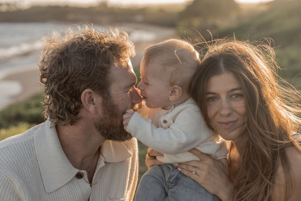 father and mother with baby on Maui