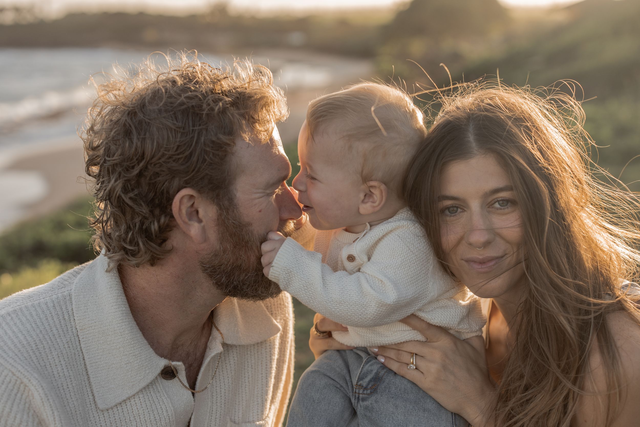 father and mother with baby on Maui