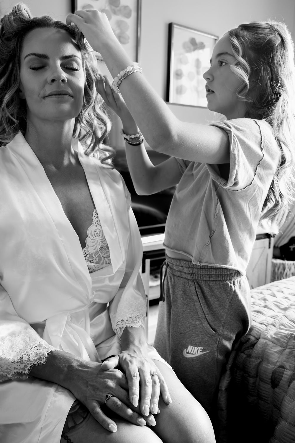 Black and white photo sequence showing tender moments between parent and child in casual clothing.