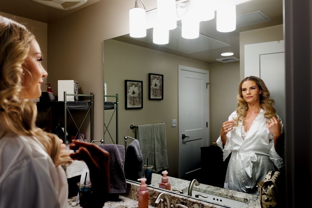 Bride adjusting her hair while getting ready for her Cambium Place wedding.