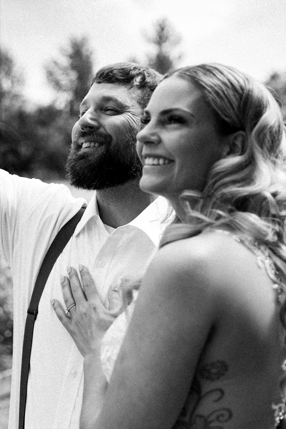 Black and white candid photo of the bride and groom kissing at their Missoula wedding ceremony.