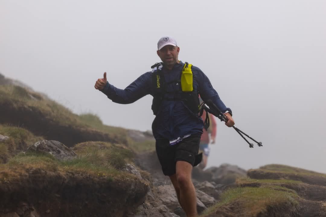Andrew Paylor racing the Skye Trail Ultra, thumbs up while running past the camera