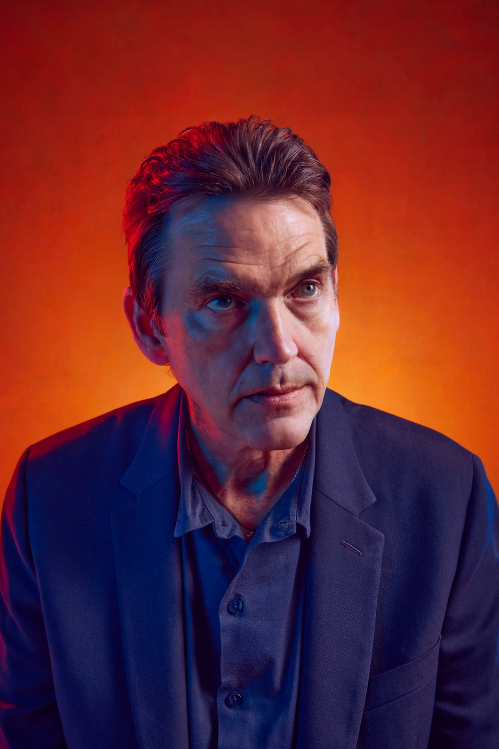Dramatic portrait series against vibrant orange background showing expressive poses.