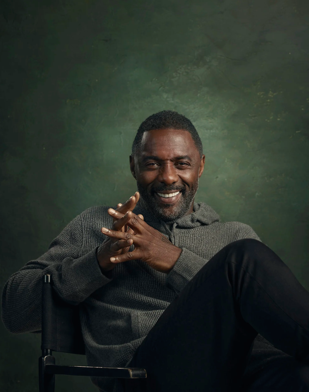 A series of expressive portraits showing a person in a gray sweater laughing and gesturing against a dark green backdrop.