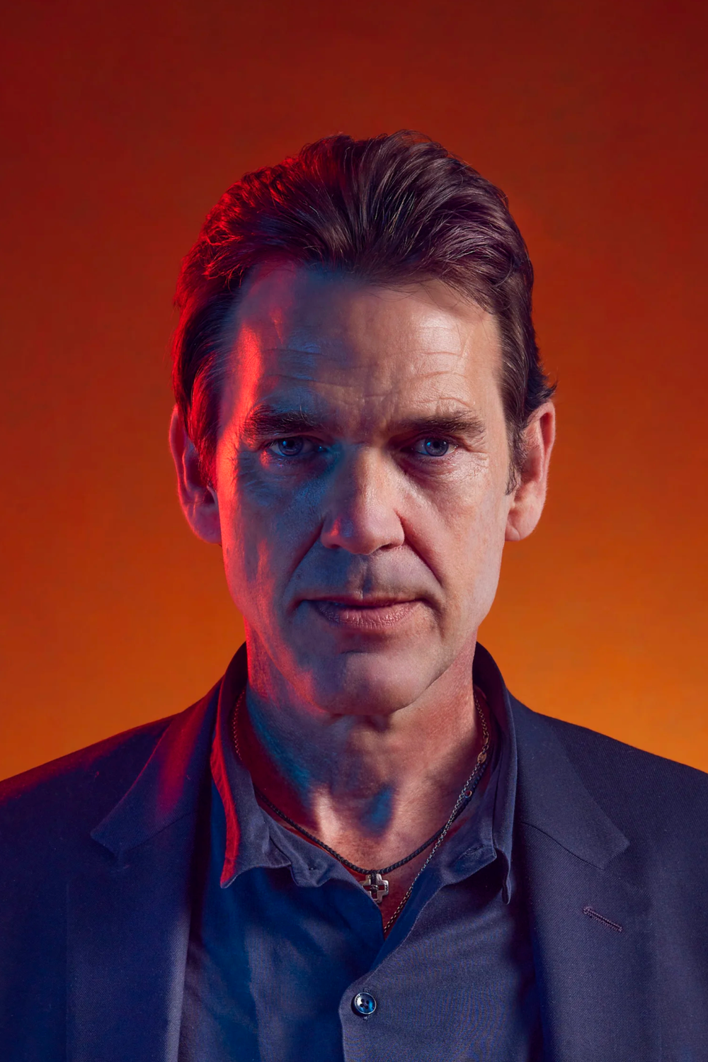 Portrait series against orange background in dramatic lighting.